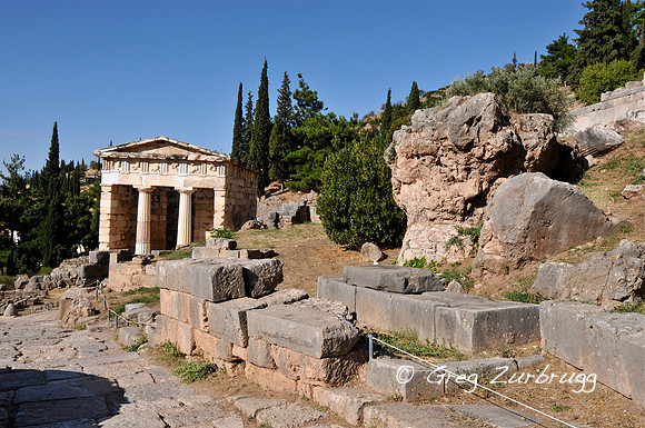 The Treasury of the Athenians on the left and the Sibyl Rock on the right. The woman who was the first oracle sat on top of this rock giving her prophecies.