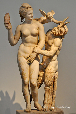 Aphrodite fending off Pan with her sandal, while Eros watches.